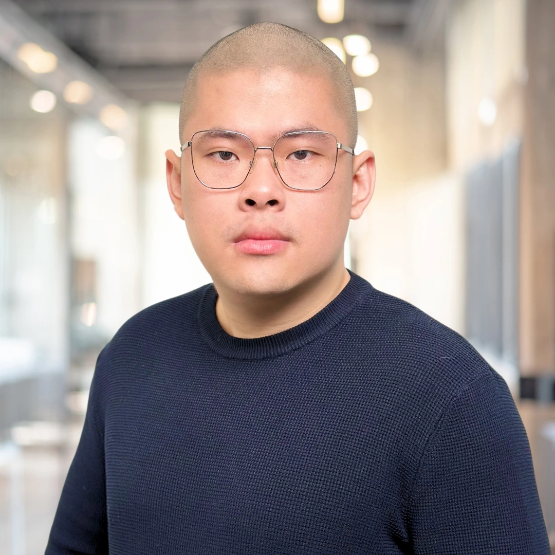 Man in glasses with a serious expression.